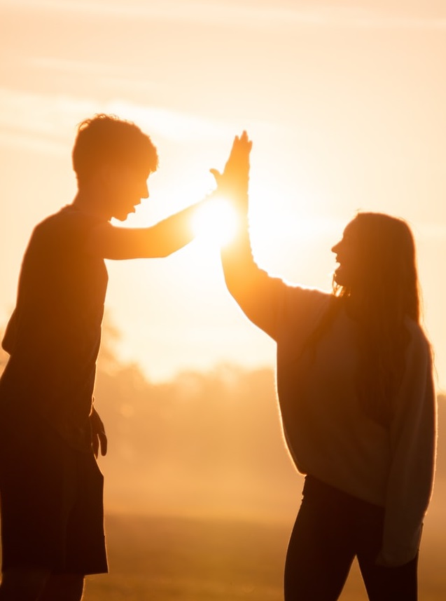 Two people high fiving